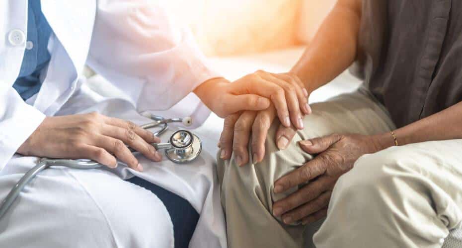 Doctor caring for a patient with Parkinson's Disease.