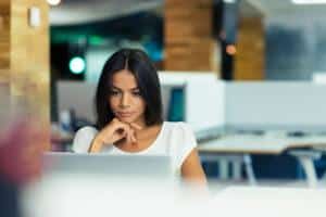 Woman looking at her laptop screen at work