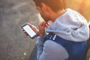 Man logging migraines on his phone. 
