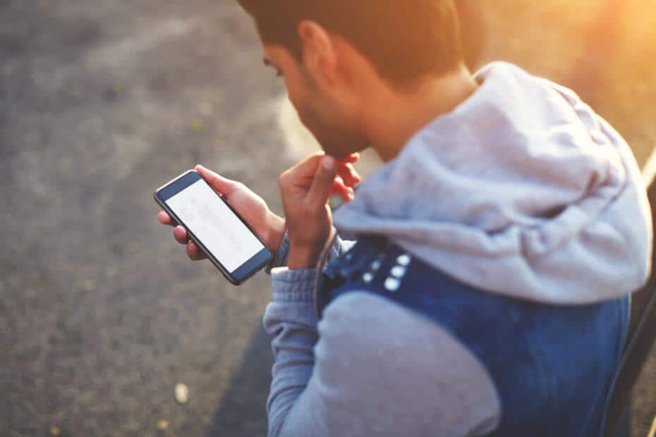 Man tracking migraines on his phone.