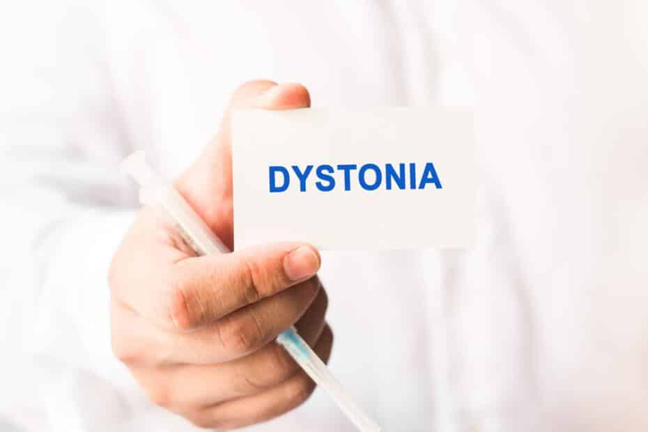 Doctor holding up card that says dystonia.
